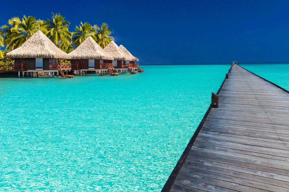Wodden-jetty-extended-into-azure-water-of-lagoon-with-villas---Maldives